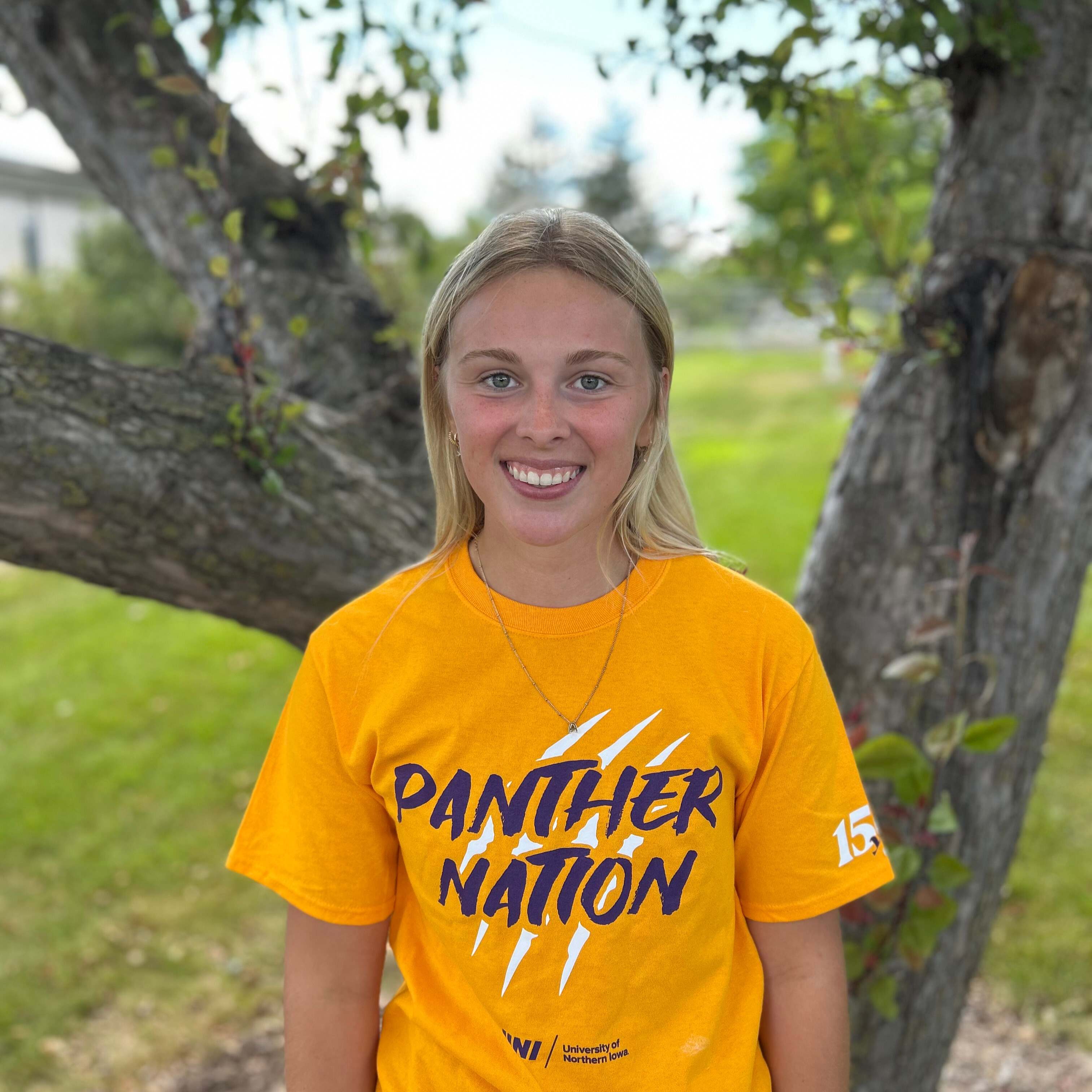 aleasha wearing gold panther nation shirt