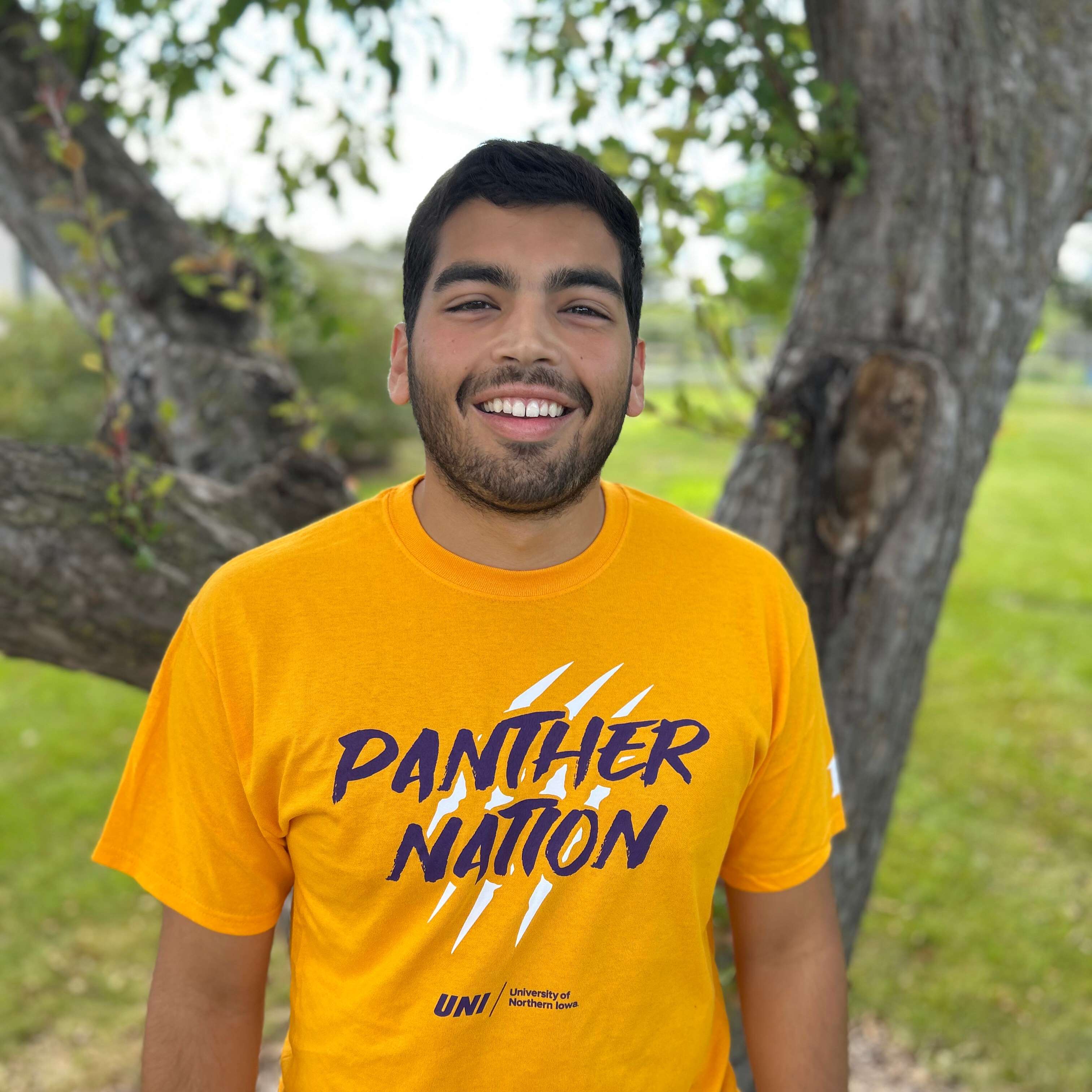 alex wearing gold panther nation shirt