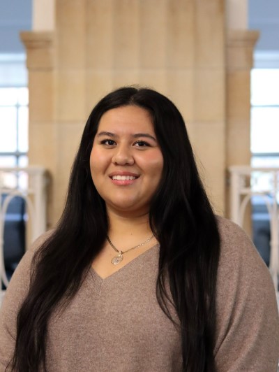 Alondra wearing a brown dress shirt