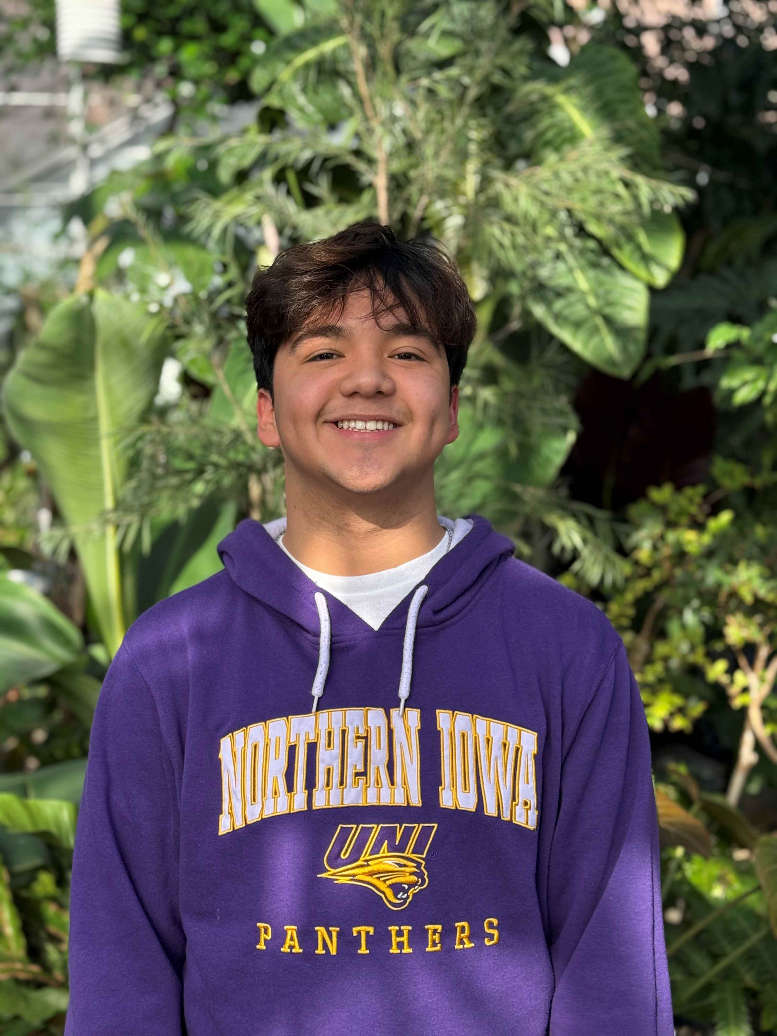 Andrew wearing purple sweatshirt