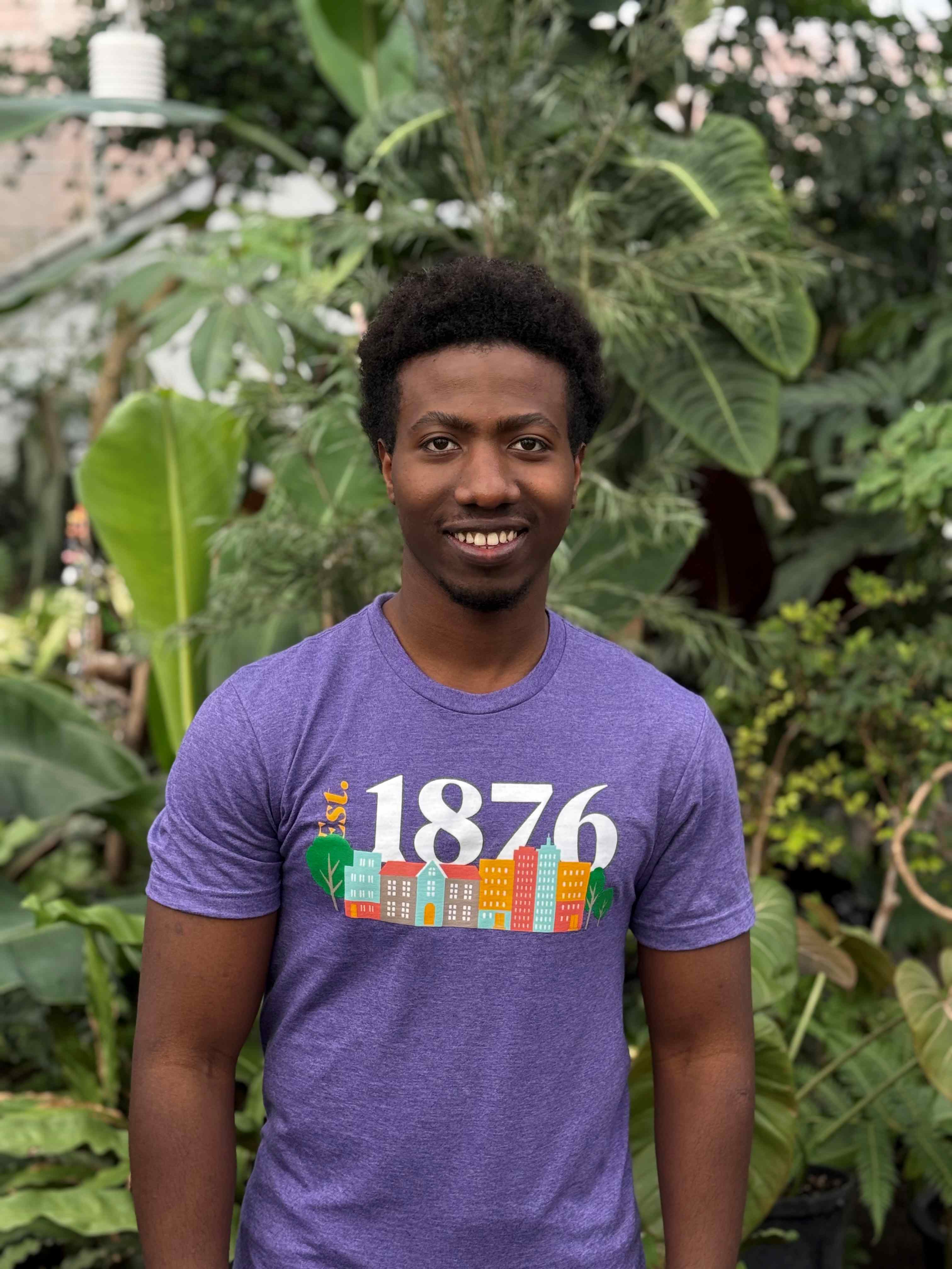 Blessing wearing purple shirt