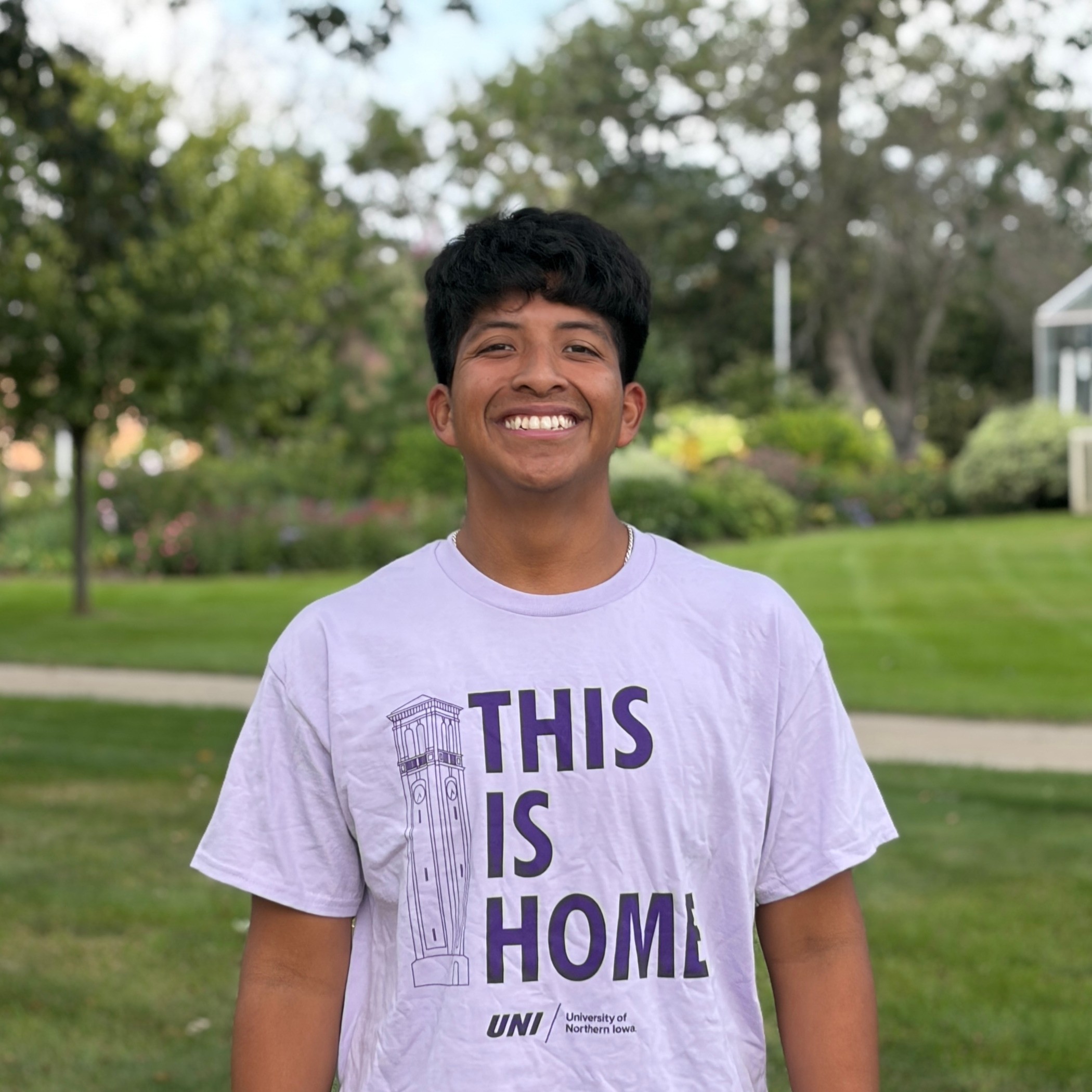 Caleb smiling wearing light purple shirt