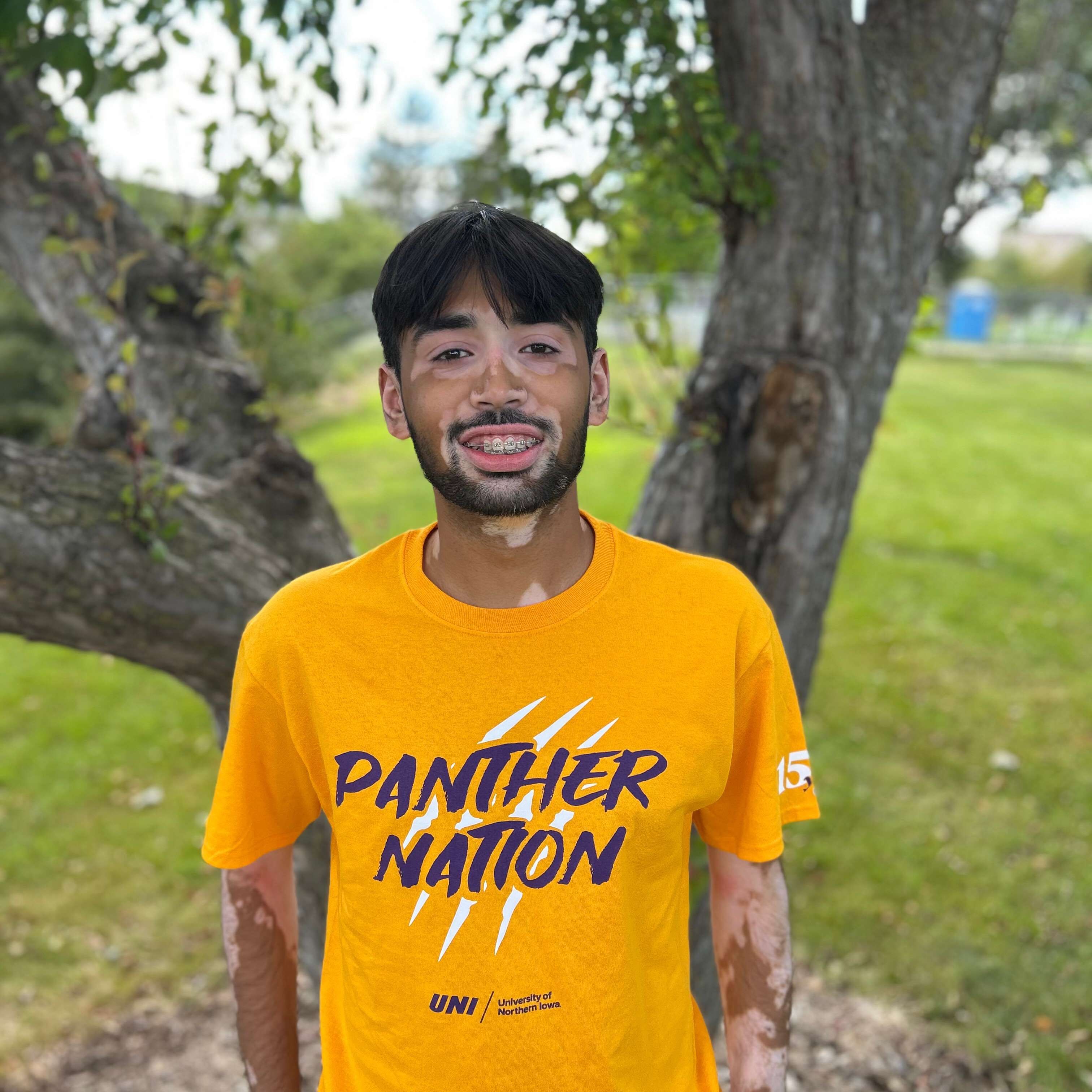 devesh wearing gold panther nation shirt