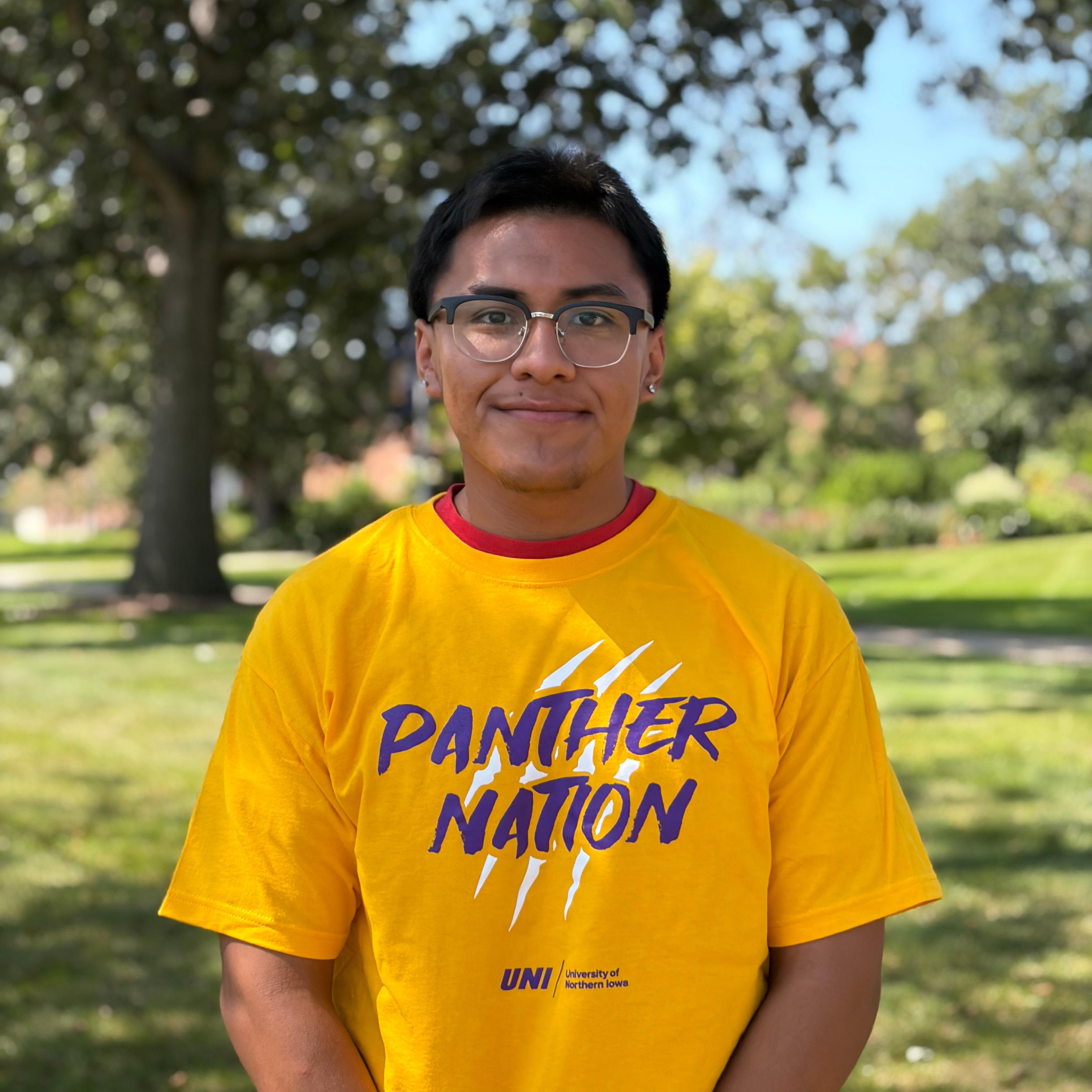 Eddy smiling wearing gold shirt