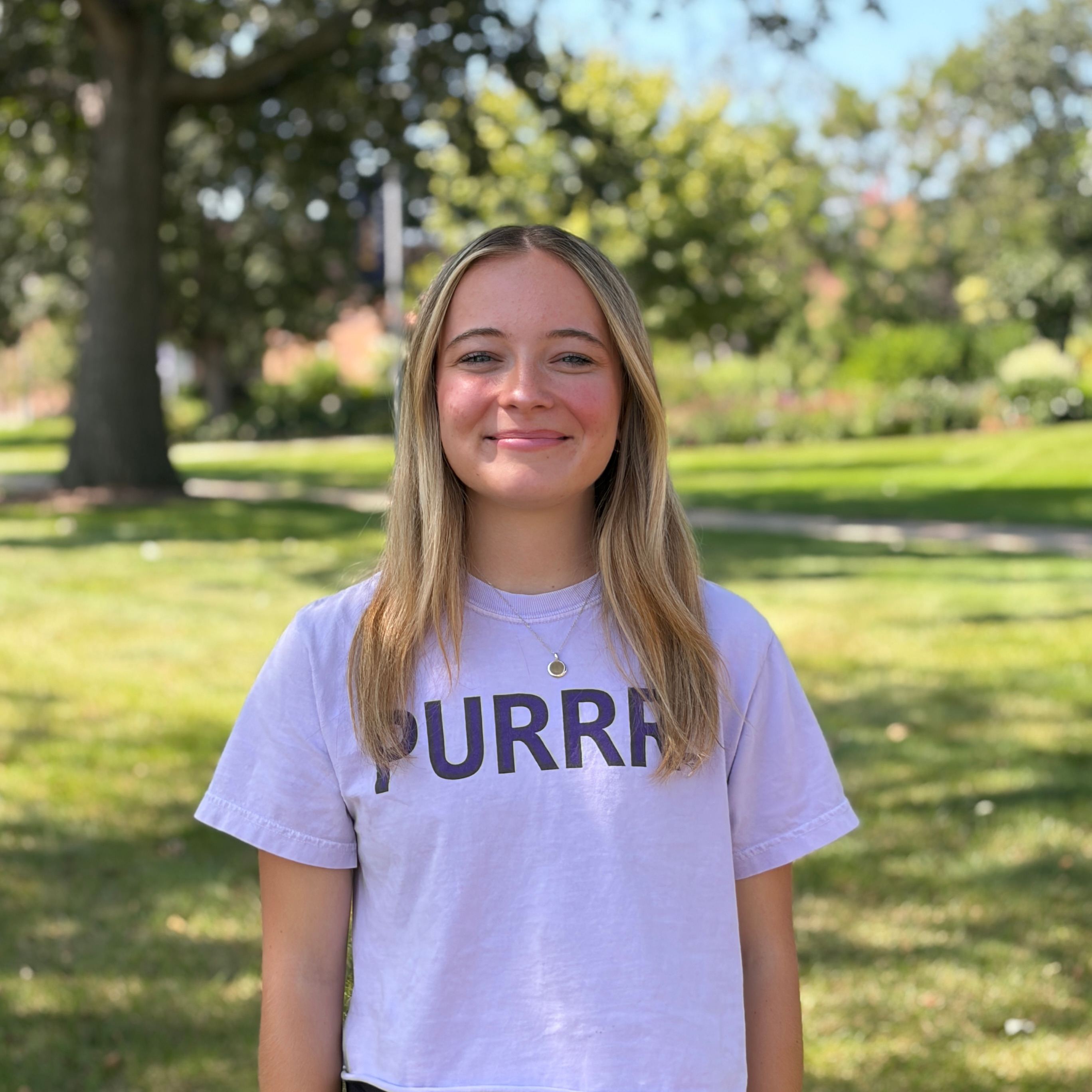 Esther smiling wearing light purple shirt
