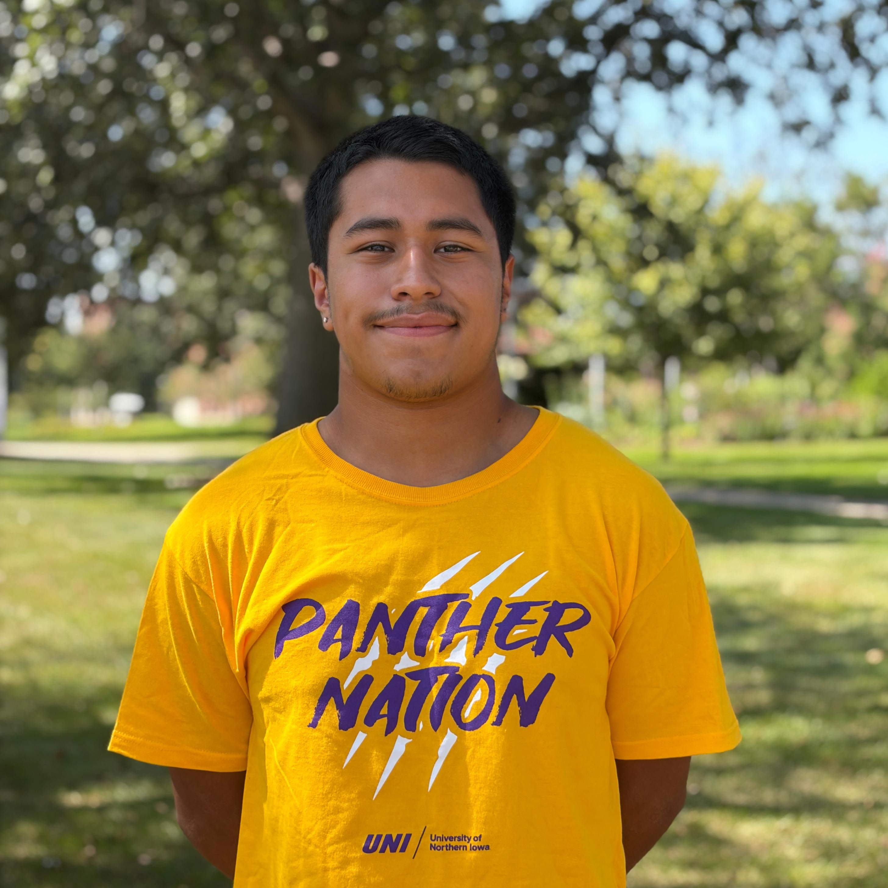 Francisco smiling wearing gold shirt