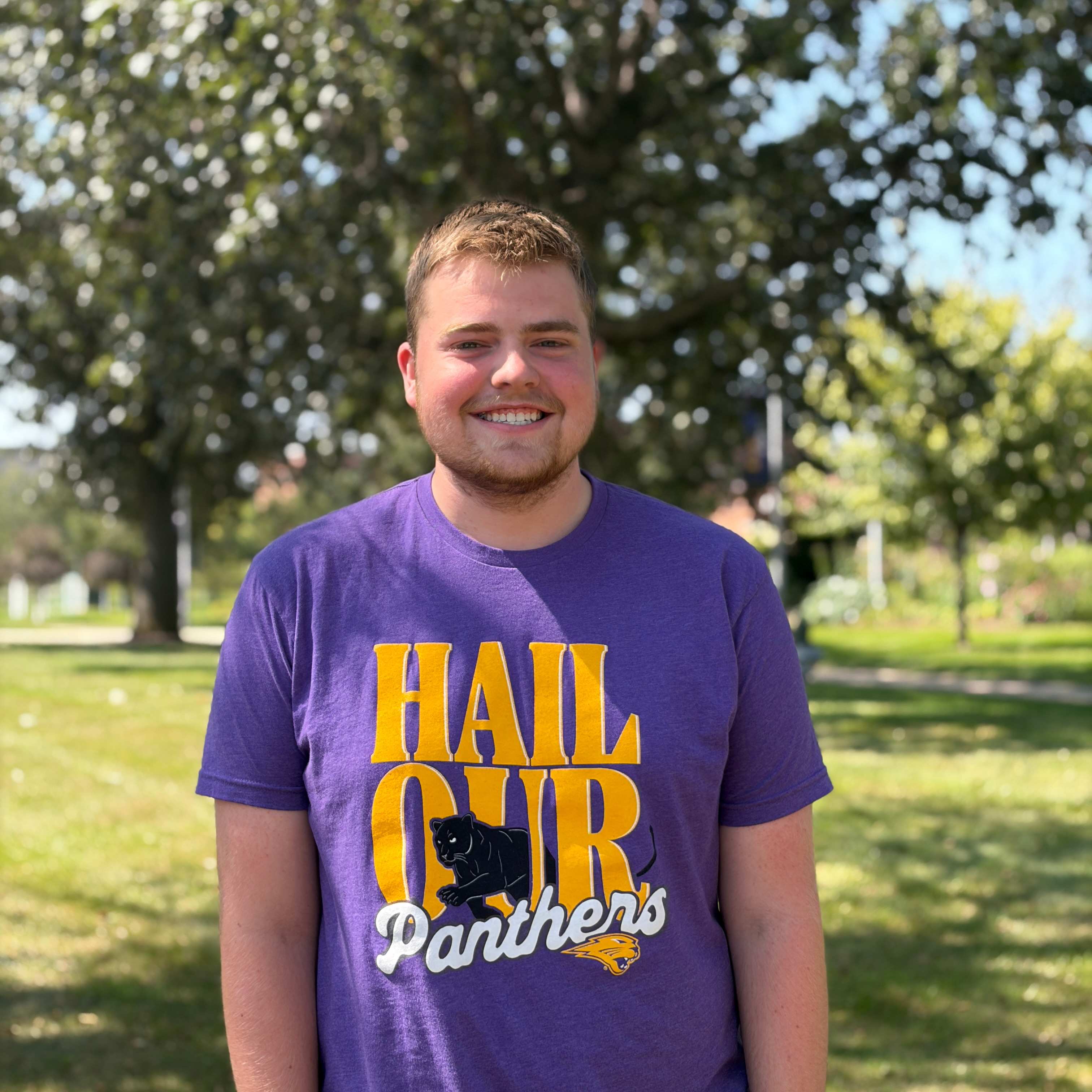 Holden smiling wearing purple shirt