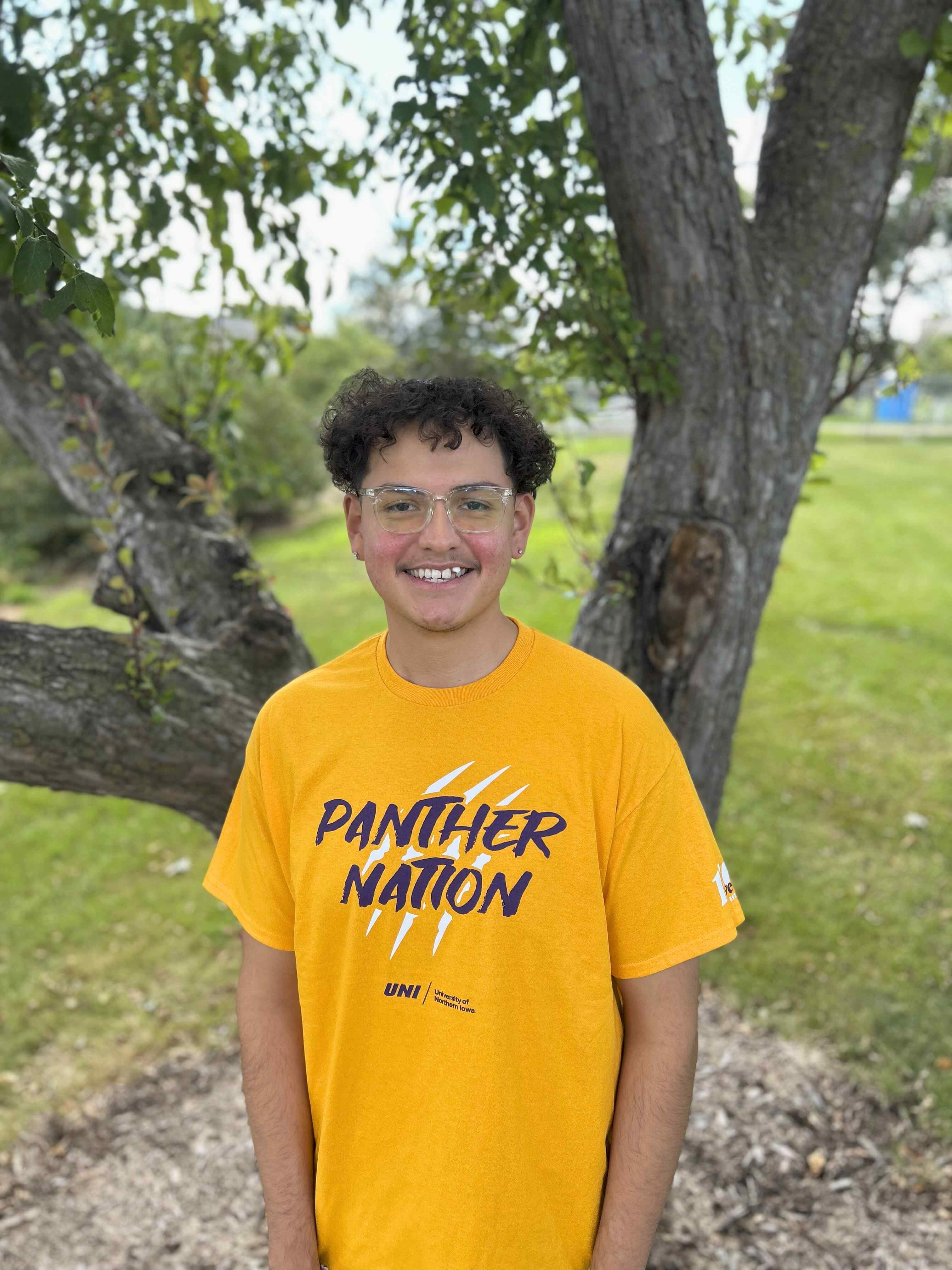 Favian wearing gold "Panther Nation" shirt