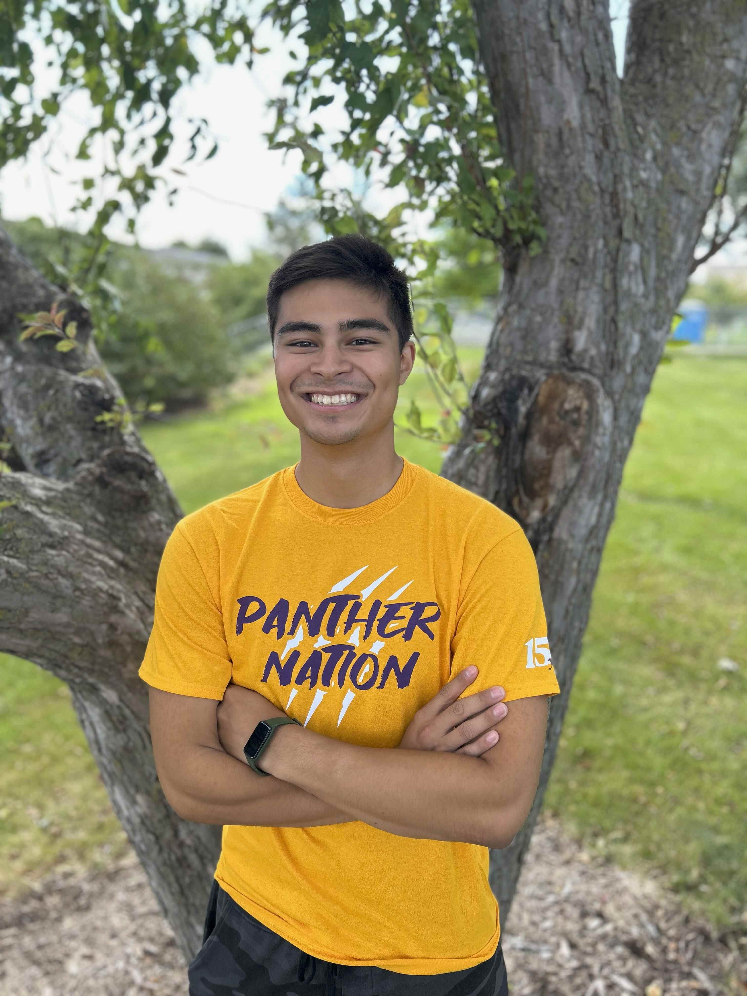 Dom wearing gold "Panther Nation" shirt