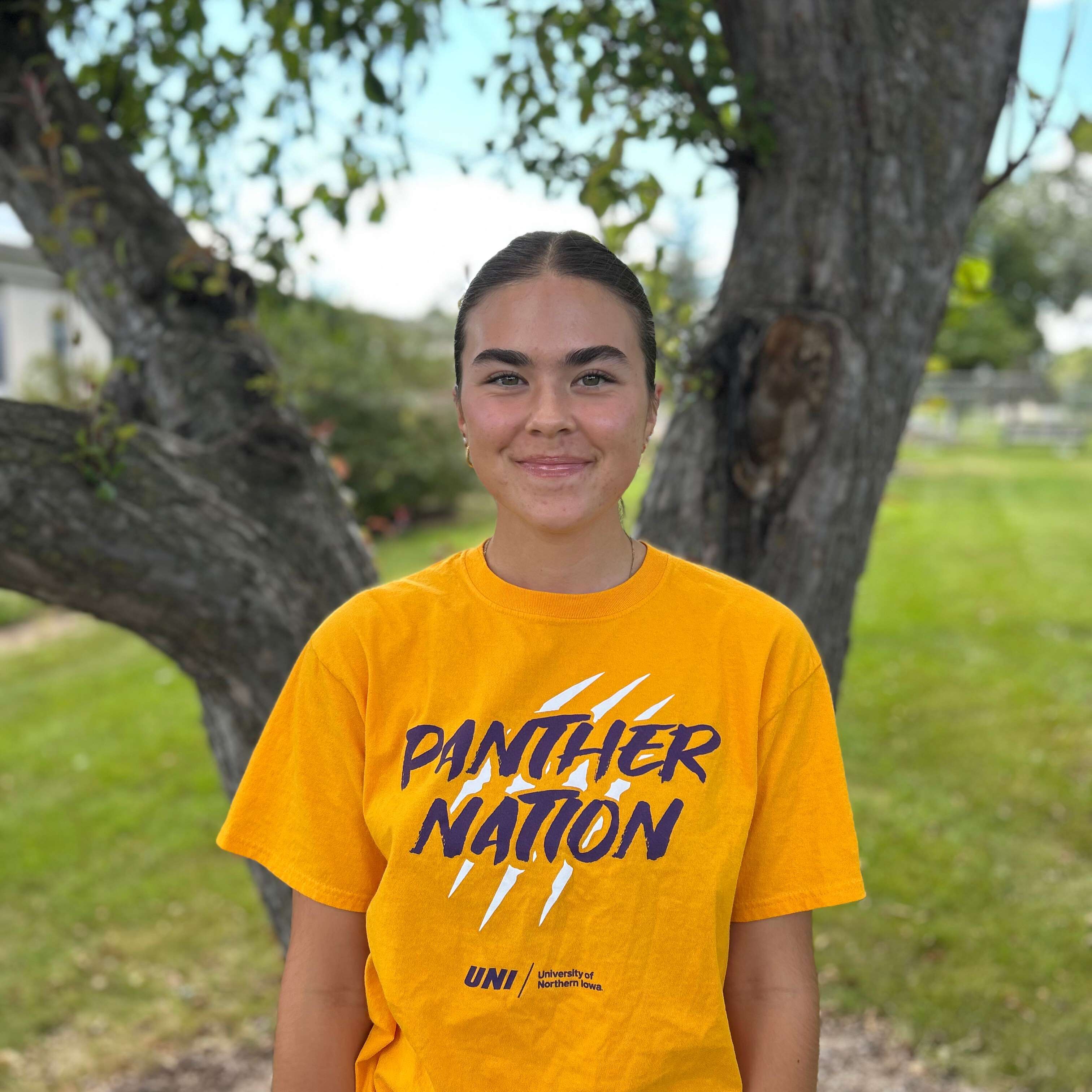 Jesika wearing gold panther nation shirt