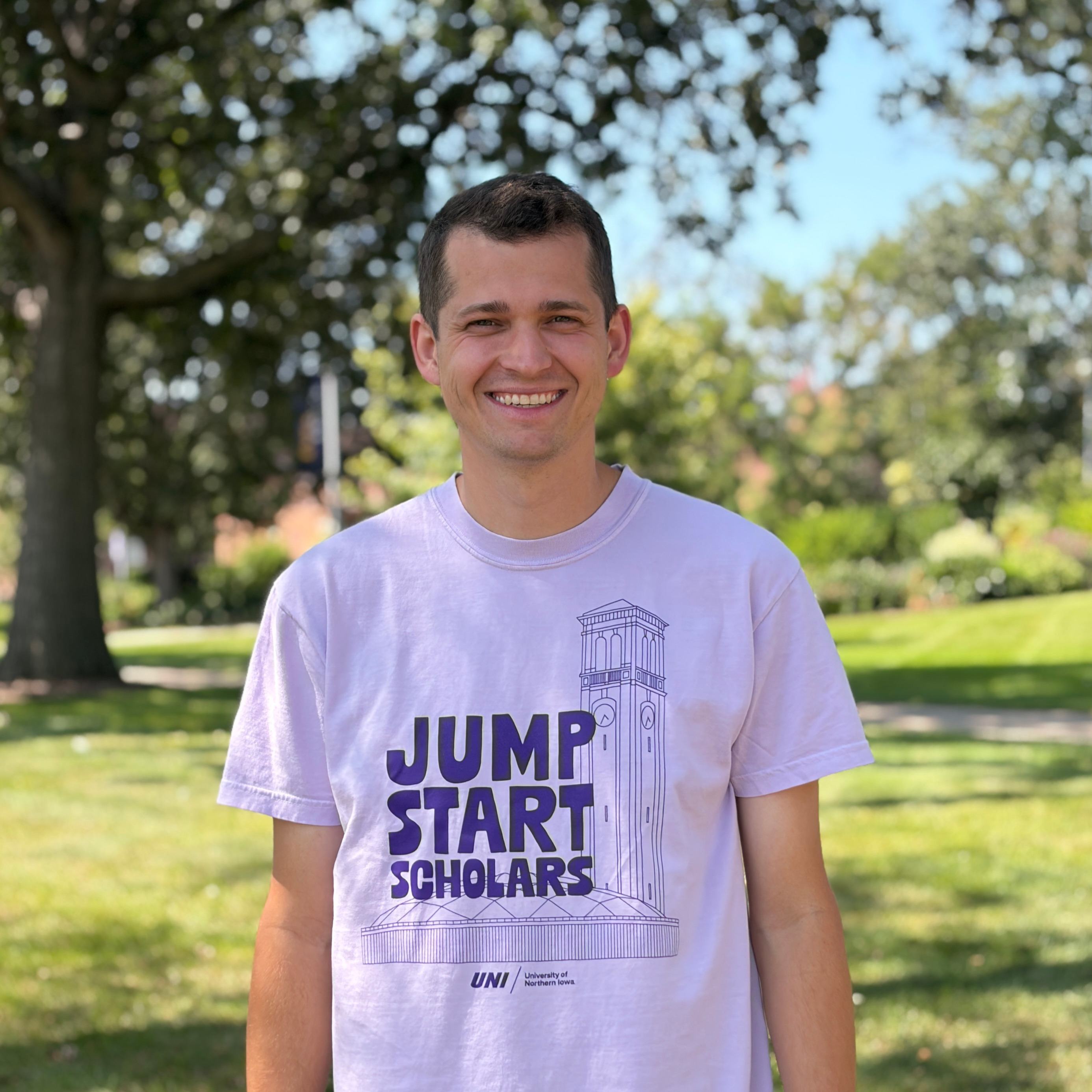 Josh smiling wearing light purple shirt