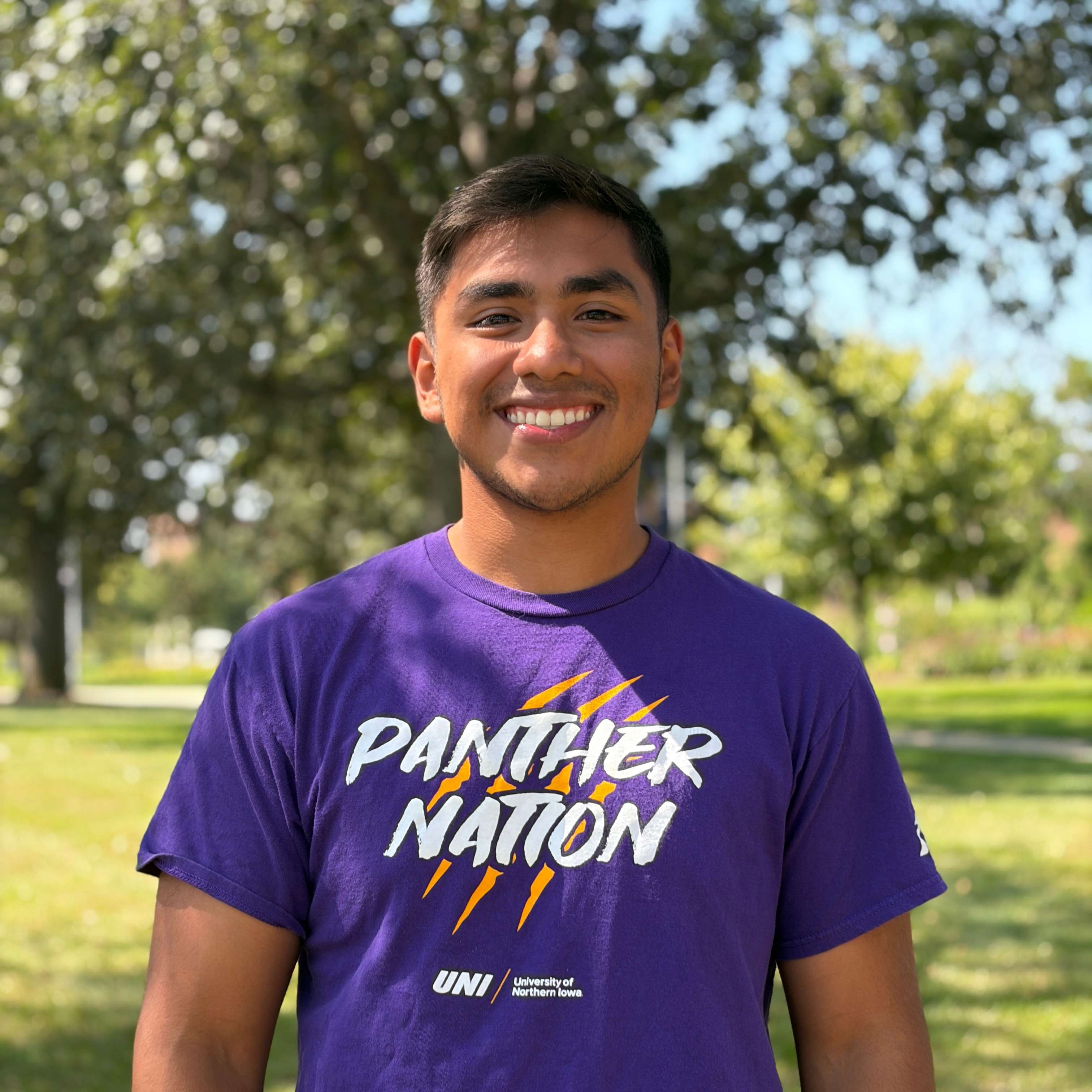 Randy smiling wearing purple shirt