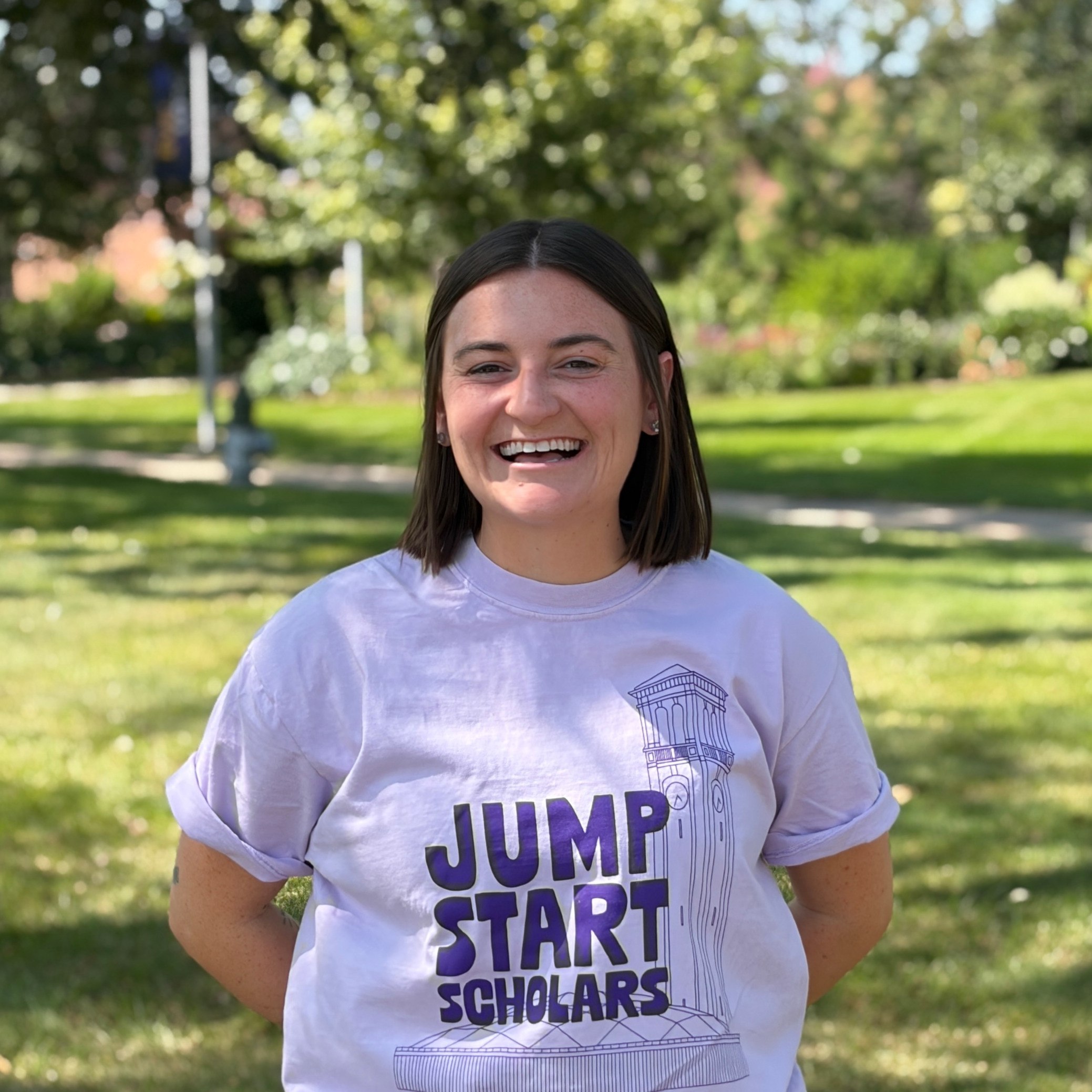 Sam smiling wearing light purple shirt