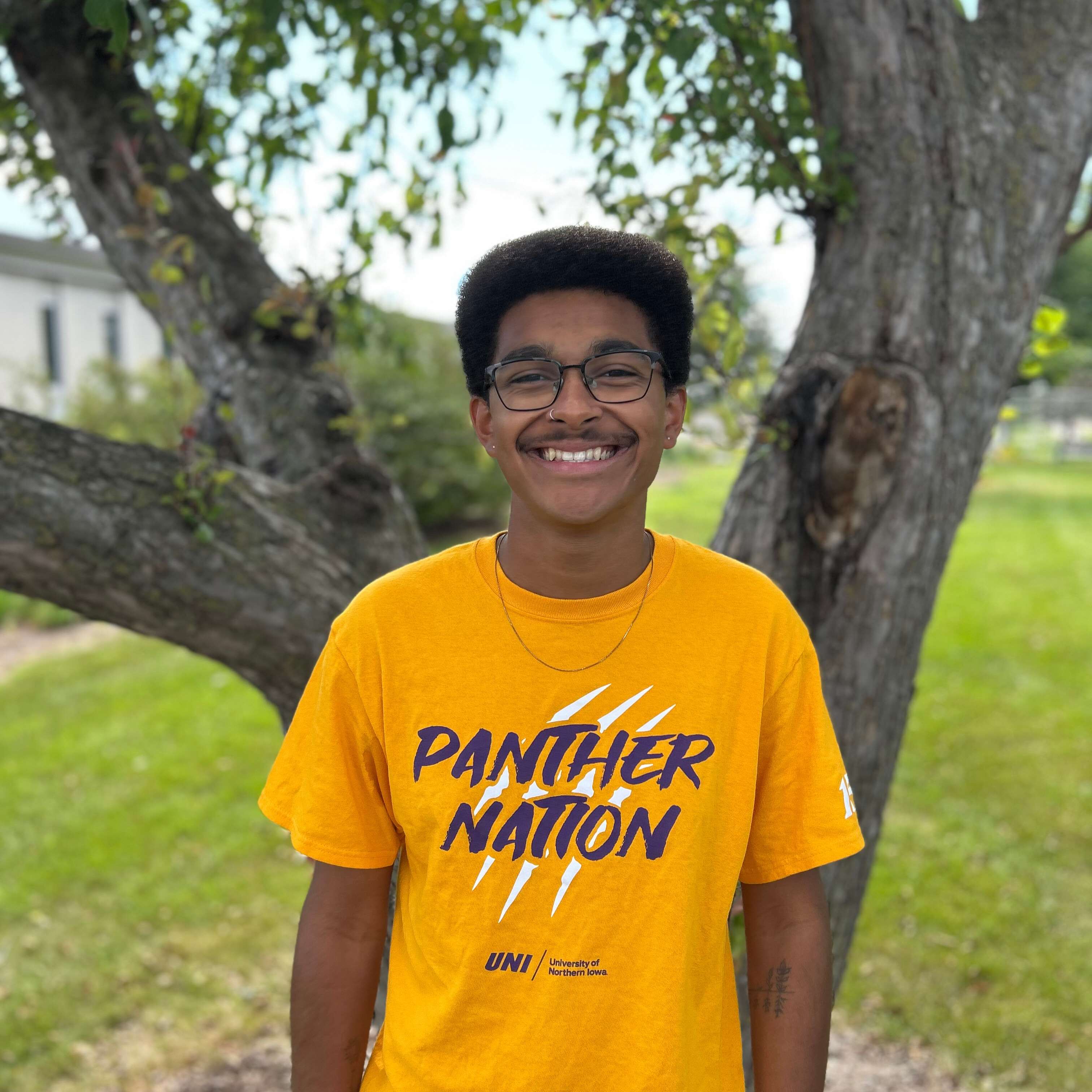 tyson wearing gold panther nation shirt