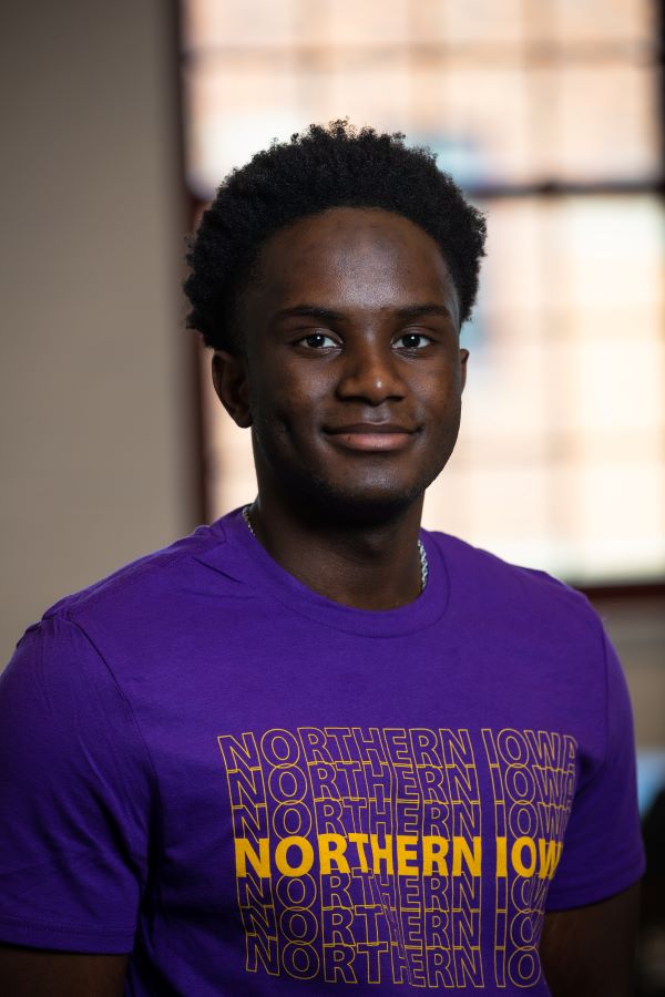 Ishimwe wearing purple UNI t-shirt