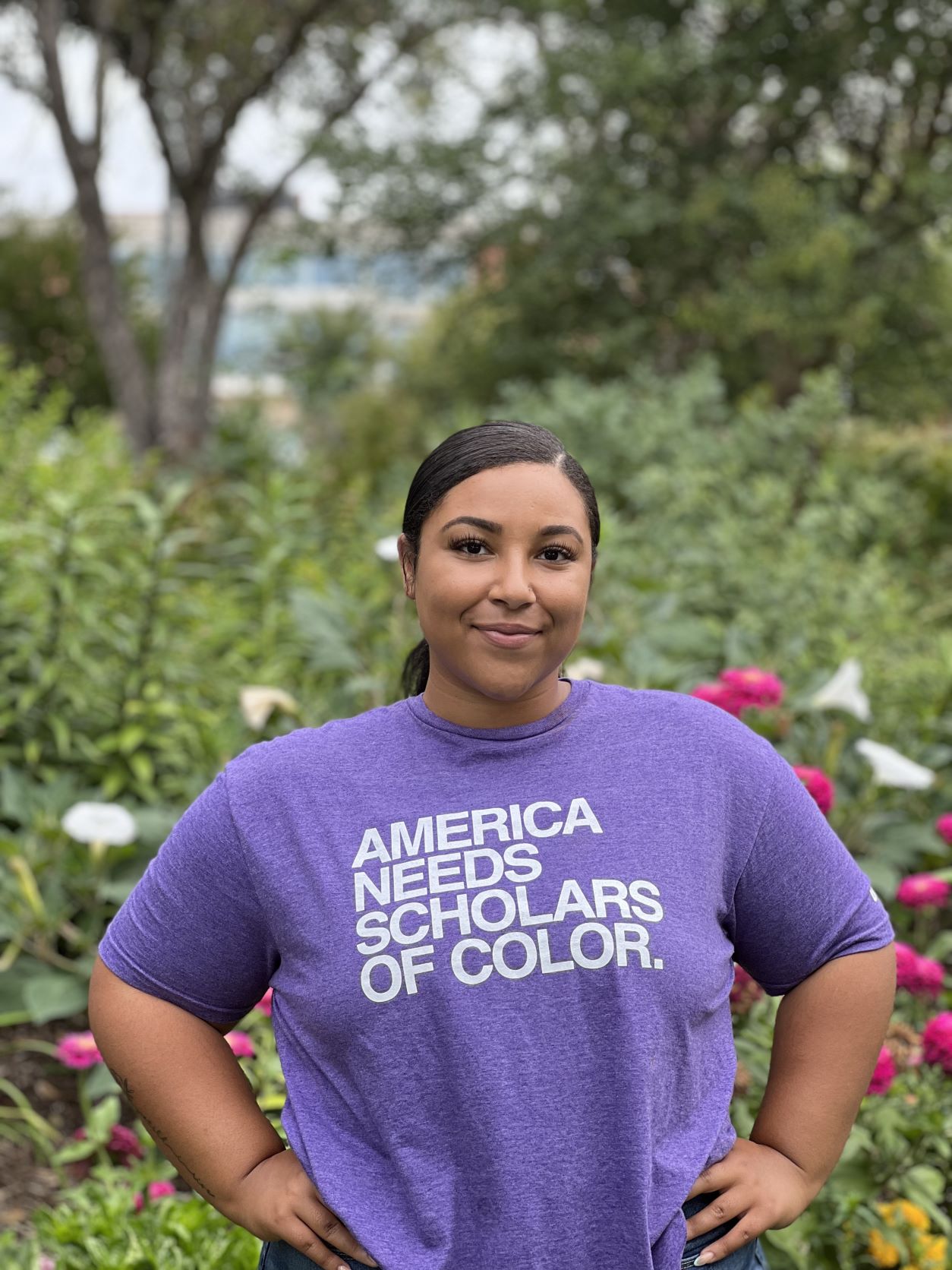 Lexi in purple UNI shirt that reads America Needs Scholars of Color. 