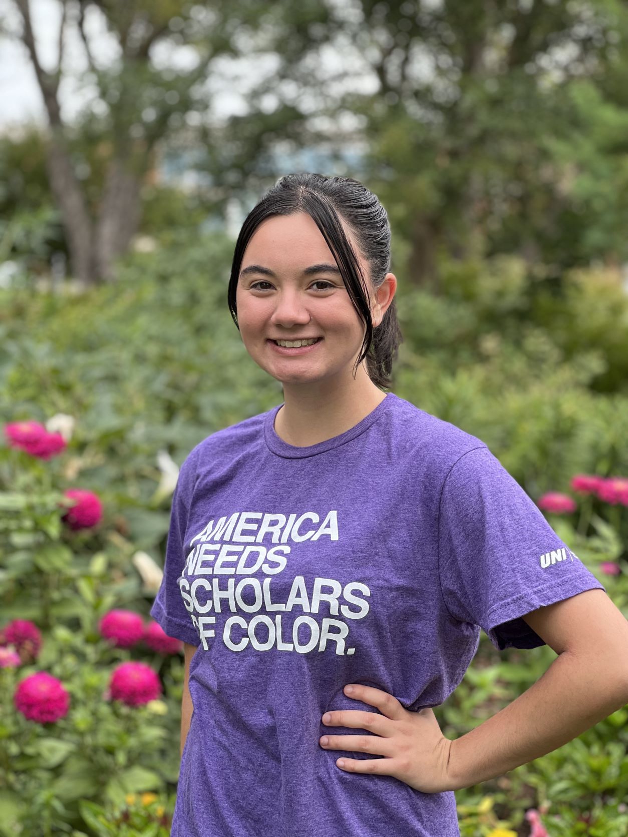 Madison in purple UNI shirt that reads America Needs Scholars of Color. 