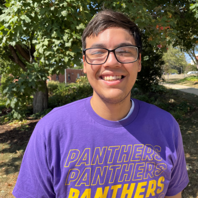 Clayton wearing a purple panther t-shirt.