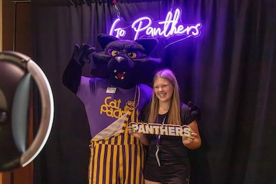 Orientation participant taking a photo with TC.