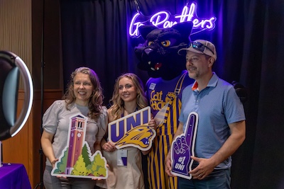 Family taking a photo with TC at Orientation.