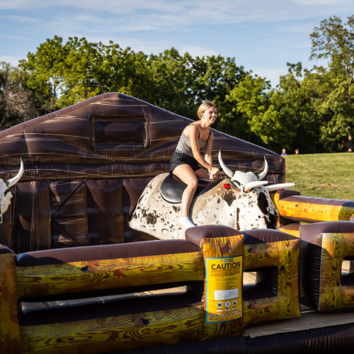 Student riding mechanical bull.