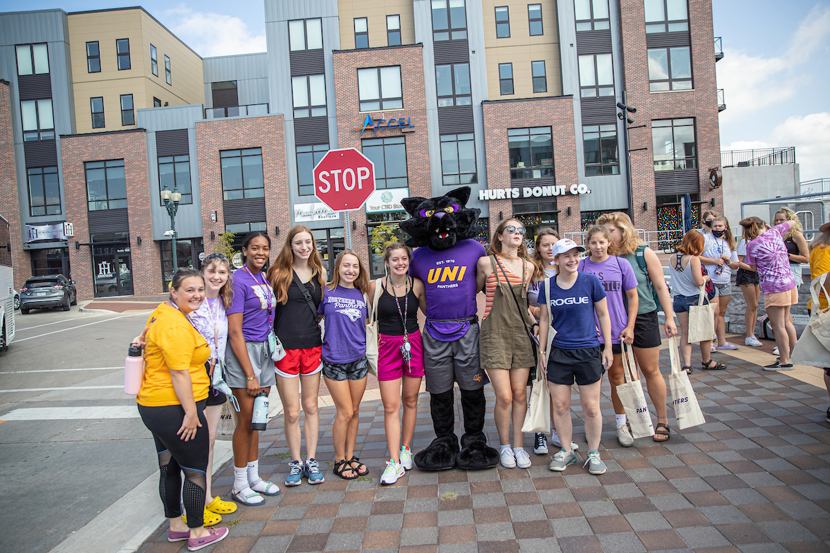 Students exploring Downtown Cedar Falls with panther mascot TC. 